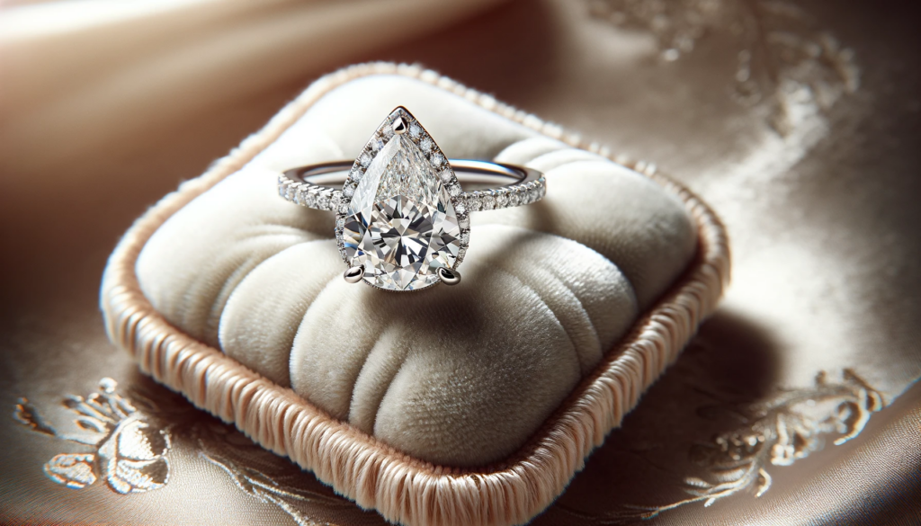  pear-shaped engagement ring delicately placed on a plush, elegant pad